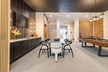 A modern clubhouse room with a table set for four